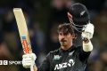 Tim Robinson raises his bat and helmet after reaching his century
