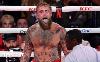 Jake Paul sticks his tongue out during a fight