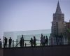 People cross a pedestrian bridge along the Las Vegas Strip during Labor Day weekend on Sunday, ...