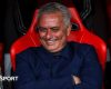 Jose Mourinho smiles and folds his arms