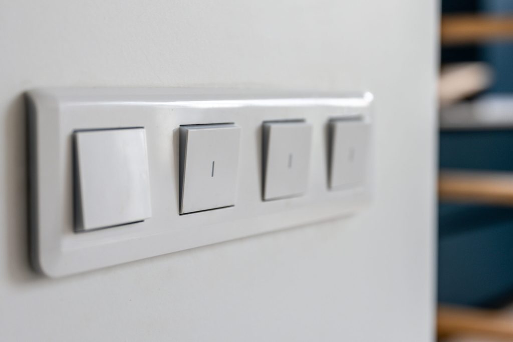 four-light-switches-macro-with-bokeh-background-minimal-design-scaled.jpg
