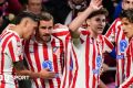Atletico Madrid players celebrate scoring four goals against Barcelona in the first half